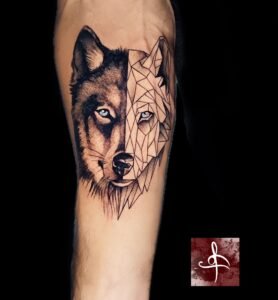 Tatouage loup moitié réaliste moitié géométrique, split face, noir et gris – jambe/bras (Rhum1 Tattoo)